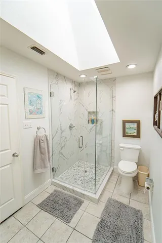 a bathroom with a shower a toilet and a shower