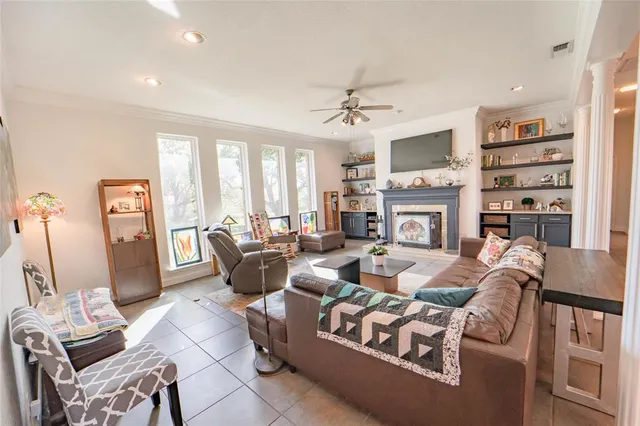 a living room with fireplace furniture and a flat screen tv