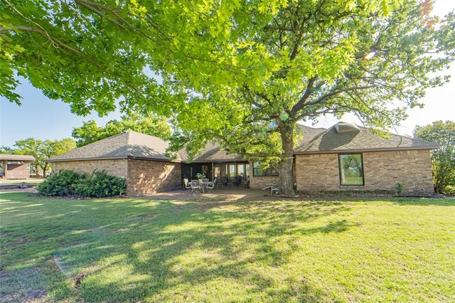 a yellow house in middle of the forest
