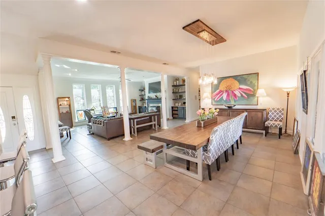 a living room with furniture a flat screen tv and kitchen view
