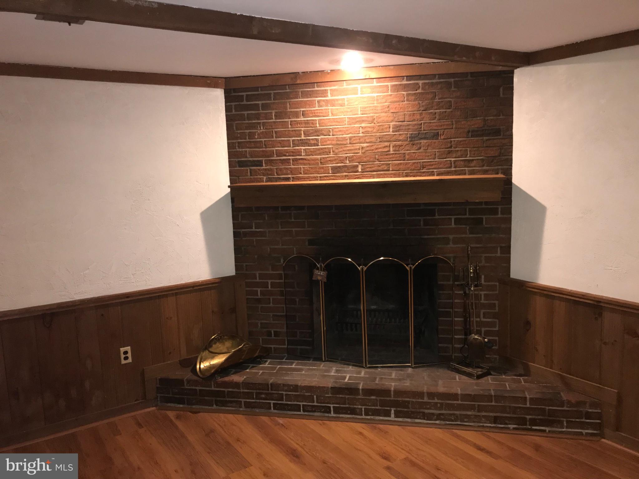 113 Kingsley Road Southwest Vienna, VA 22180 - Photo 27 of 40 Cozy brick fireplace with rustic charm.
