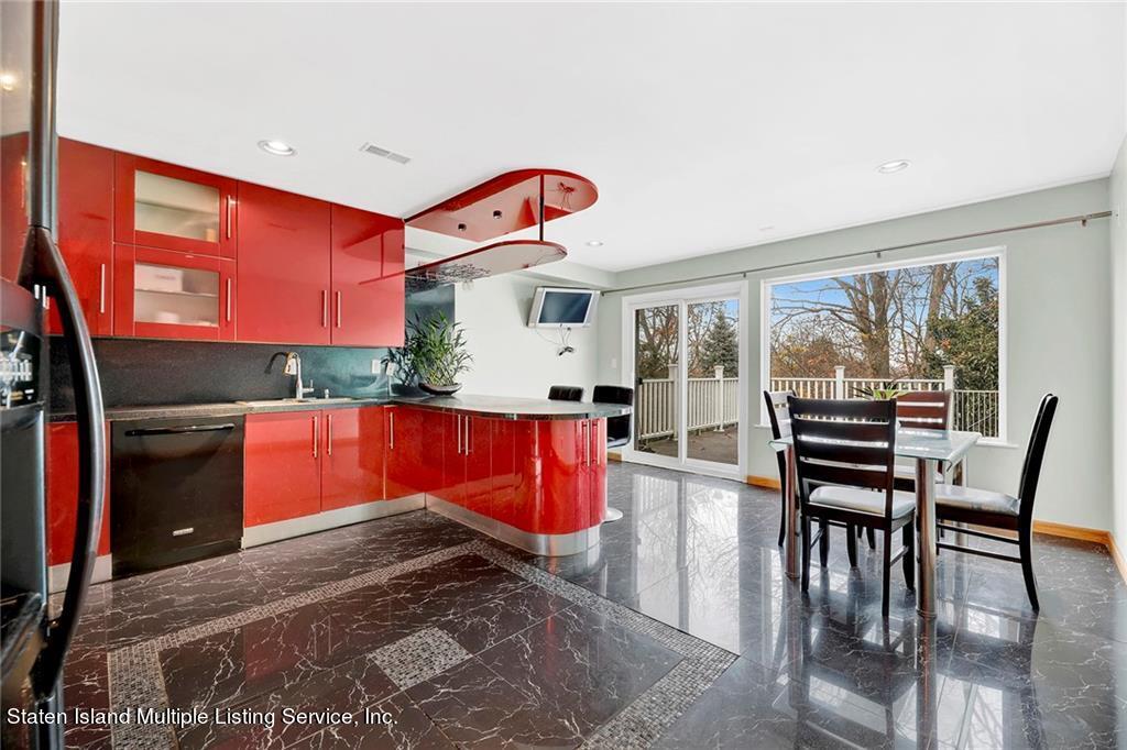 a kitchen with stainless steel appliances kitchen island granite countertop a stove top oven a dining table and chairs