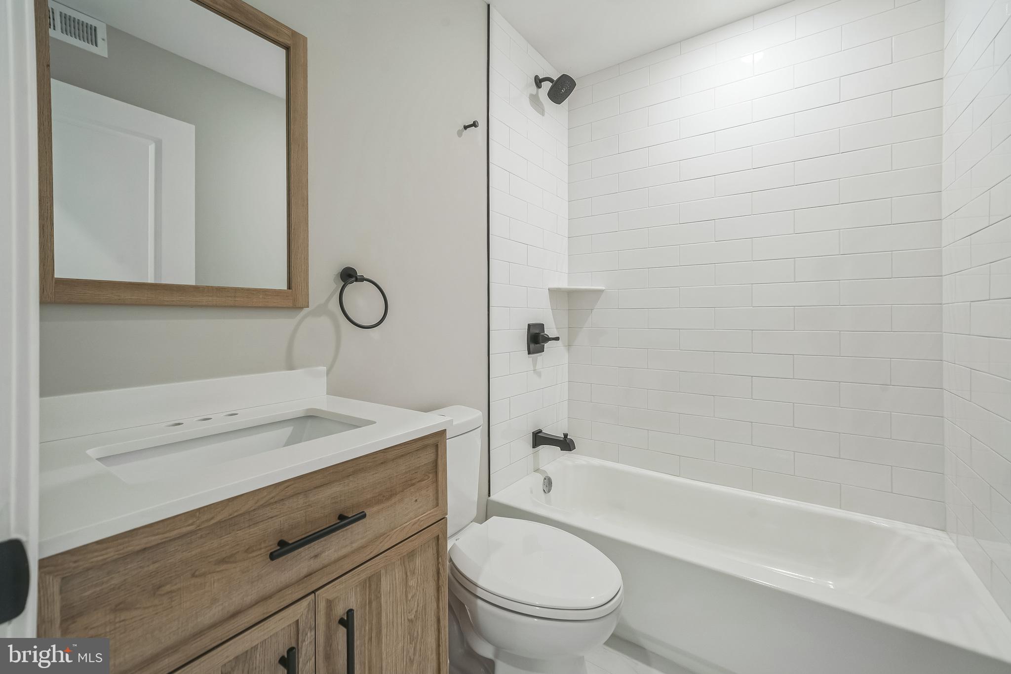 1702 South 22nd Street, Unit 3 Philadelphia, PA 19145 - Photo 13 of 22 a bathroom with a sink a toilet and shower