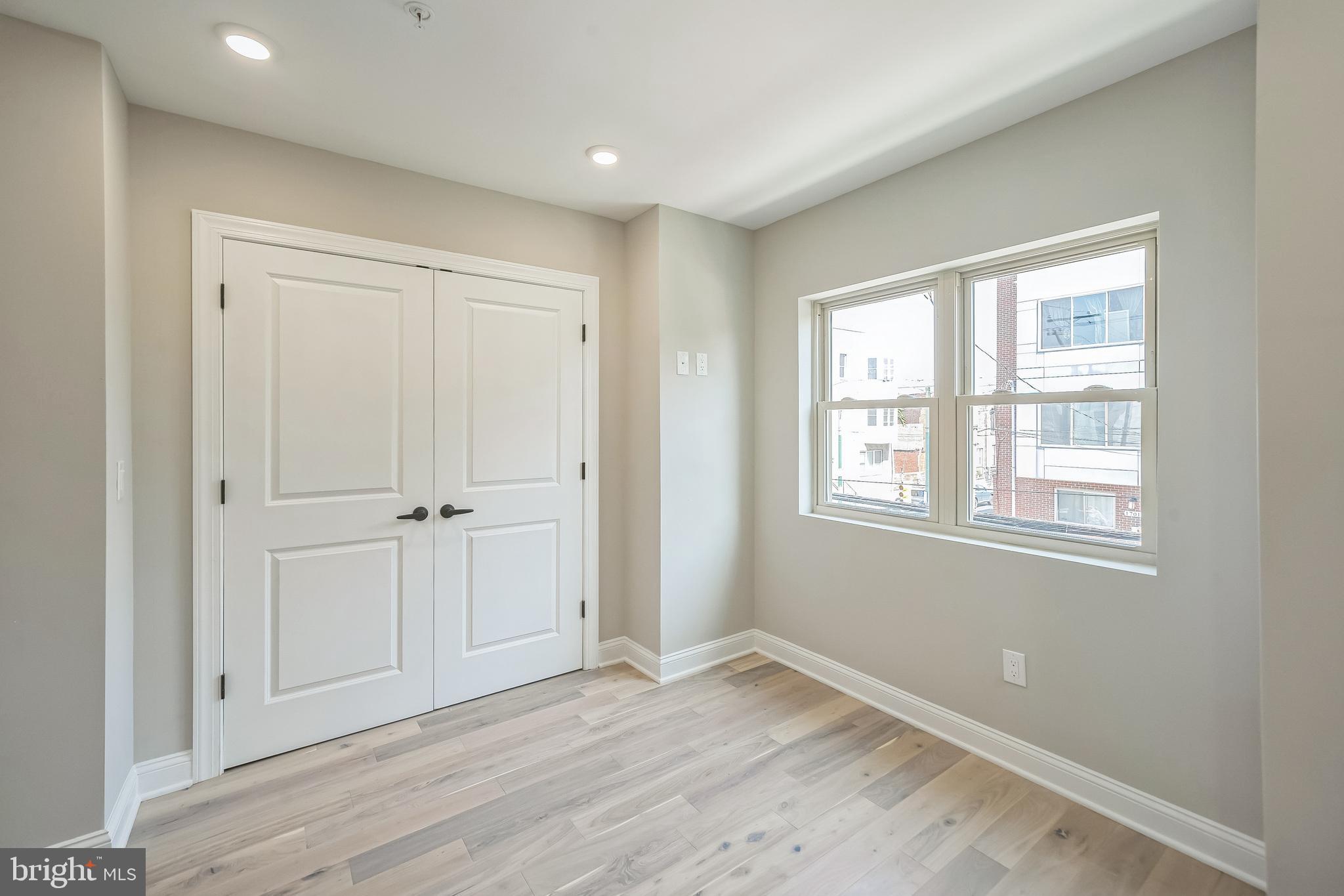 1702 South 22nd Street, Unit 3 Philadelphia, PA 19145 - Photo 14 of 22 a view of an empty room with wooden floor and window
