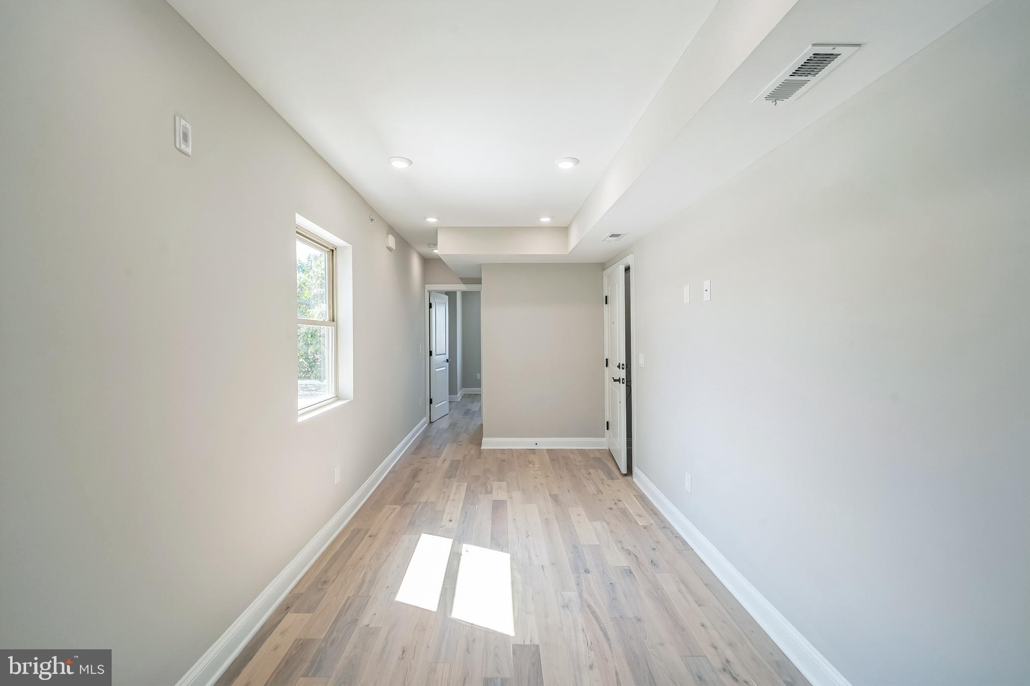 1702 South 22nd Street, Unit 3 Philadelphia, PA 19145 - Photo 20 of 22 a view of empty room with wooden floor and fan