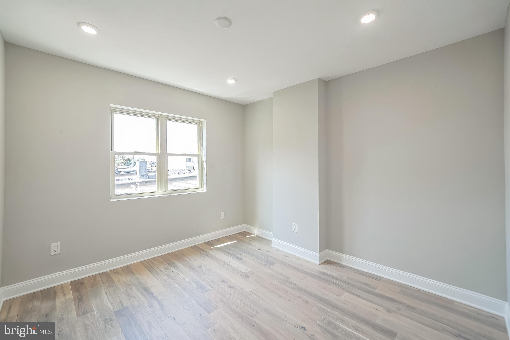 1702 South 22nd Street, Unit 3 Philadelphia, PA 19145 - Photo 21 of 22 an empty room with wooden floor and windows