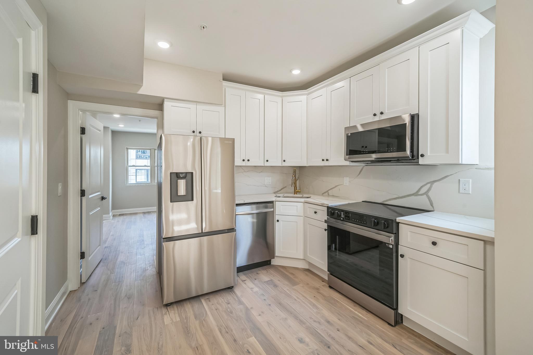 1702 South 22nd Street, Unit 3 Philadelphia, PA 19145 - Photo 5 of 22 a kitchen with stainless steel appliances a refrigerator sink and microwave