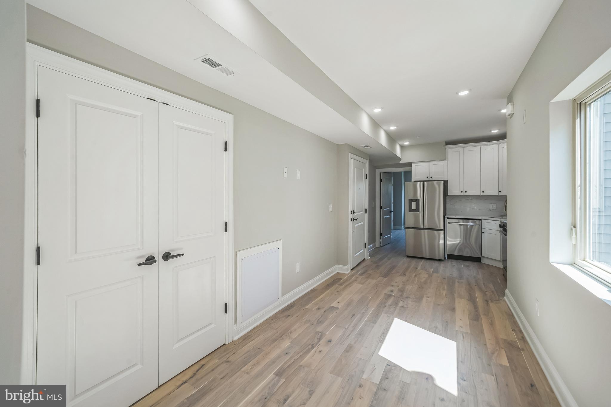 1702 South 22nd Street, Unit 3 Philadelphia, PA 19145 - Photo 7 of 22 a view of a kitchen with wooden cabinet and refrigerator