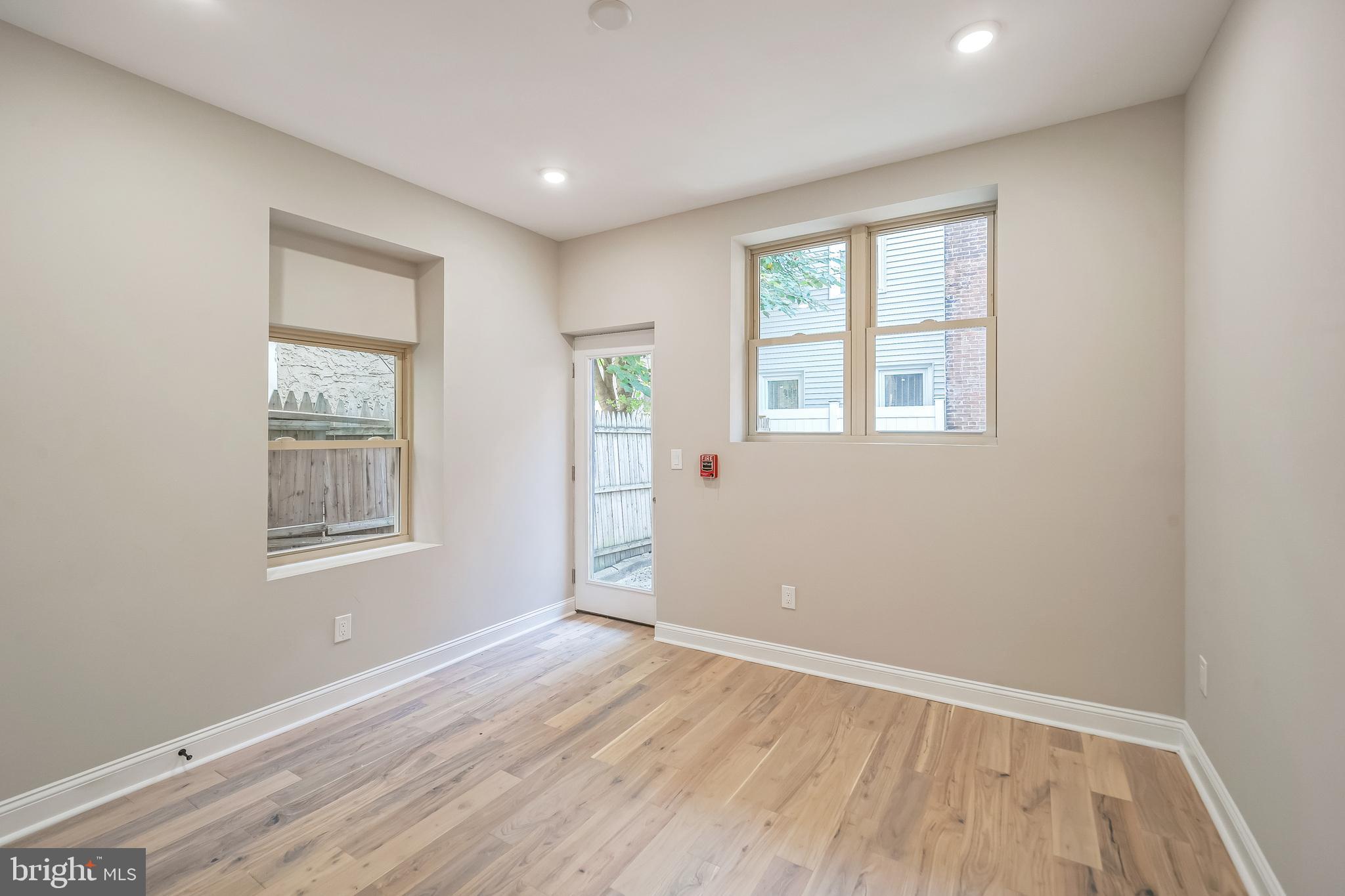 1702 South 22nd Street, Unit 3 Philadelphia, PA 19145 - Photo 8 of 22 an empty room with wooden floor and windows