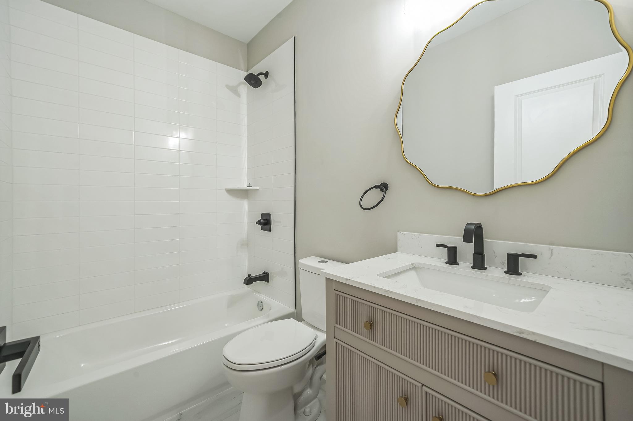 1702 South 22nd Street, Unit 3 Philadelphia, PA 19145 - Photo 9 of 22 a bathroom with a sink a toilet and shower