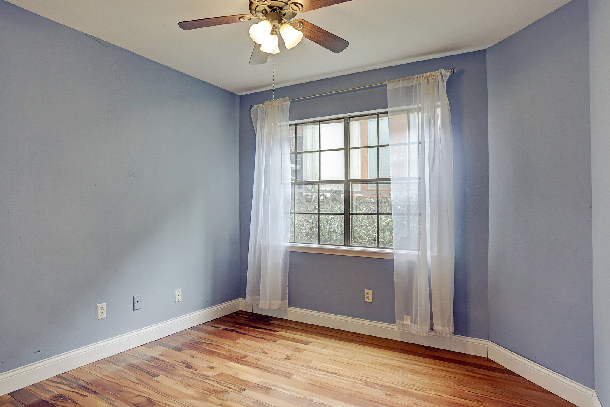 4320 Hazard Street Houston, TX 77098 - Photo 19 of 24 an empty room with wooden floor and windows