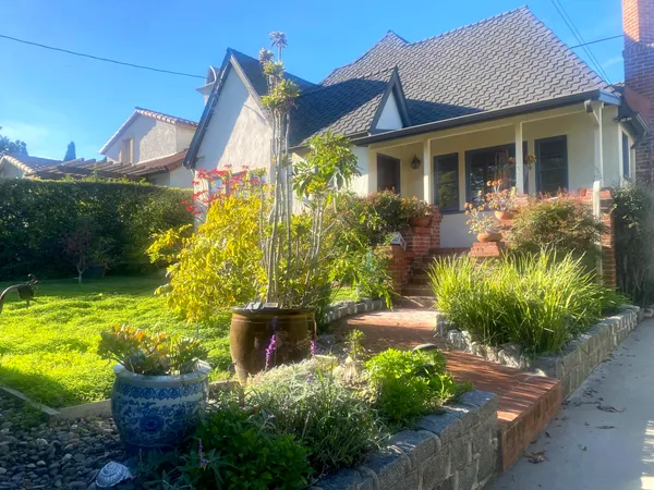 a front view of a house with garden