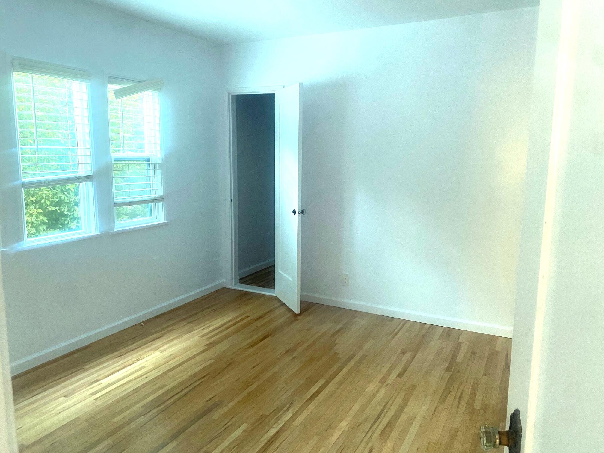 324 Arden Road Santa Barbara, CA 93105 - Photo 12 of 17 an empty room with wooden floor and windows