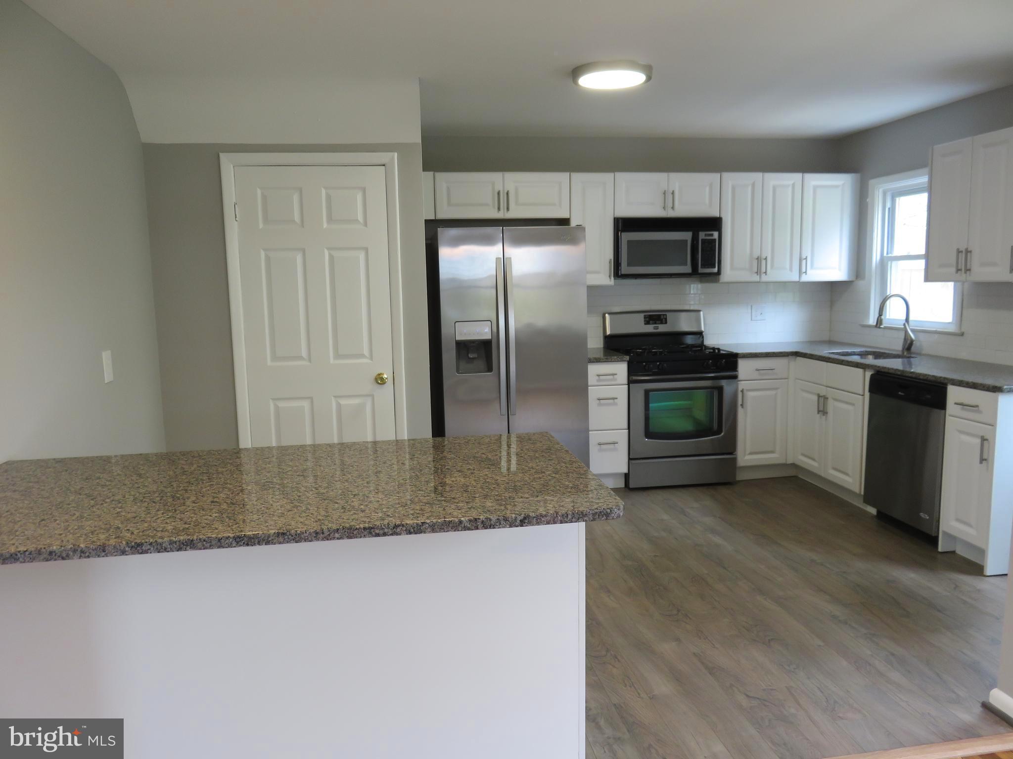 6840 Queens Ferry Road Baltimore, MD 21239 - Photo 3 of 28 TASTEFULLY UPDATED KITCHEN OPEN TO DINING ROOM