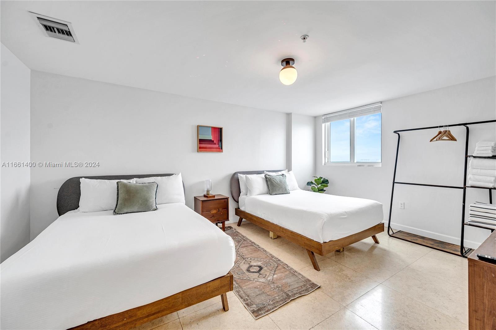 7939 East Drive, Unit 13 North Bay Village, FL 33141 - Photo 13 of 31 a bedroom with a bed and window