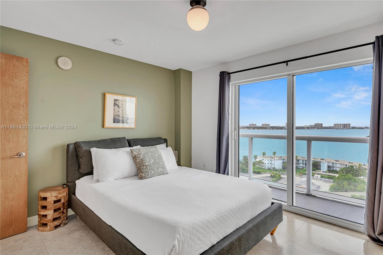 7939 East Drive, Unit 13 North Bay Village, FL 33141 - Photo 14 of 31 a bedroom with a large bed and a large window