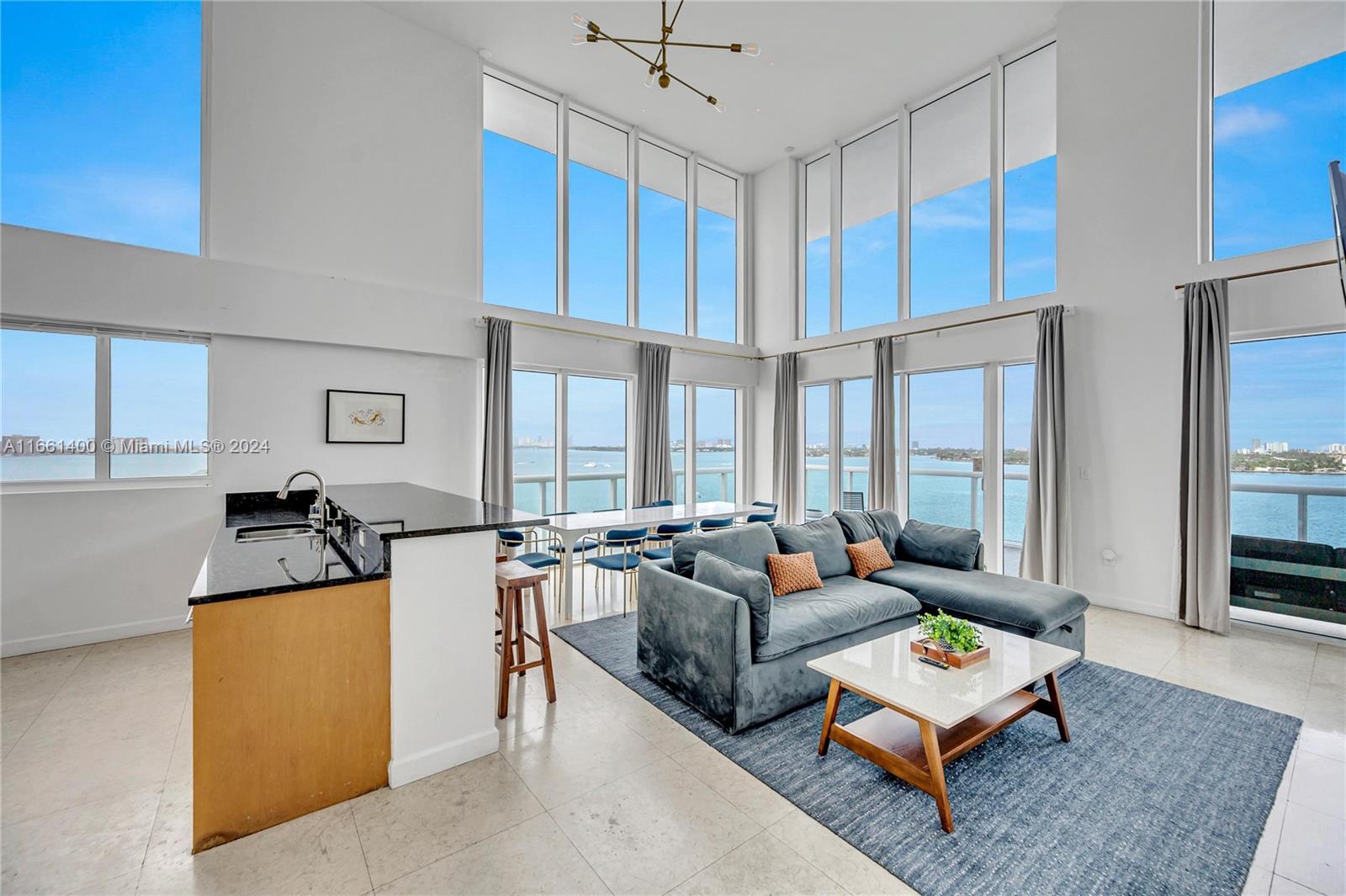 7939 East Drive, Unit 13 North Bay Village, FL 33141 - Photo 24 of 31 a living room with furniture and a large window