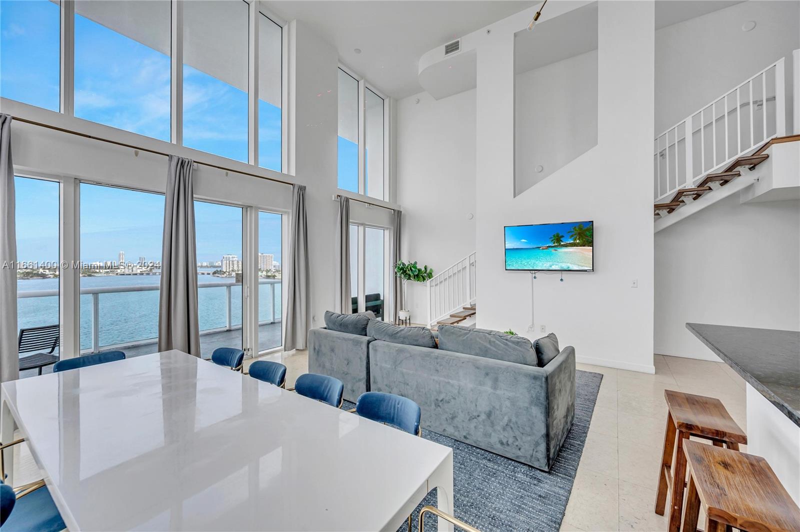 7939 East Drive, Unit 13 North Bay Village, FL 33141 - Photo 3 of 31 a living room with furniture wooden floor and a large window
