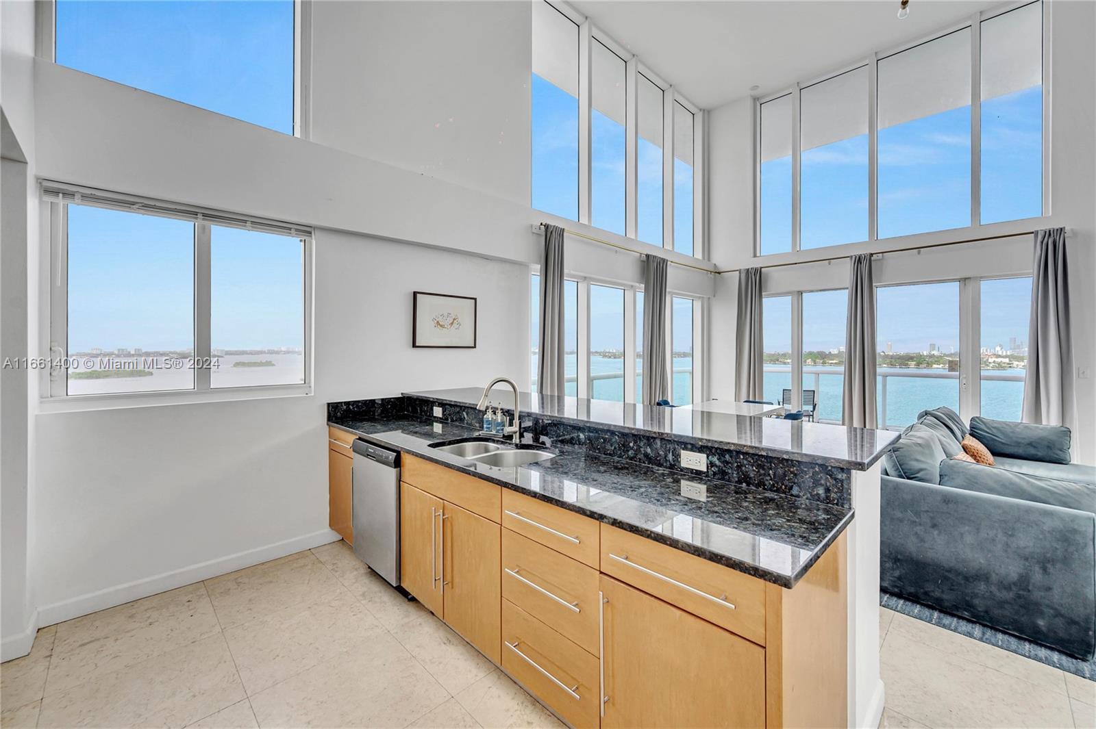 7939 East Drive, Unit 13 North Bay Village, FL 33141 - Photo 6 of 31 a kitchen with granite countertop a sink and a counter top space