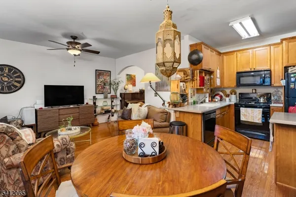 a living room with furniture kitchen view and a flat screen tv