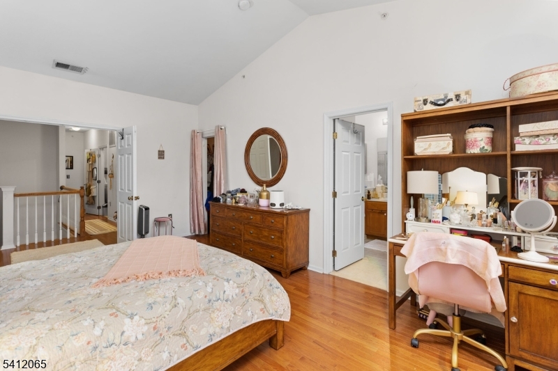 411 Deluca Road, Unit 411 Belleville, NJ 07109 - Photo 20 of 39 a bedroom with a bed and dresser with mirror
