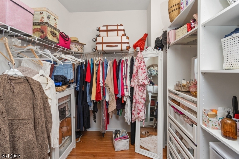 411 Deluca Road, Unit 411 Belleville, NJ 07109 - Photo 21 of 39 a view of walk in closet with clothes