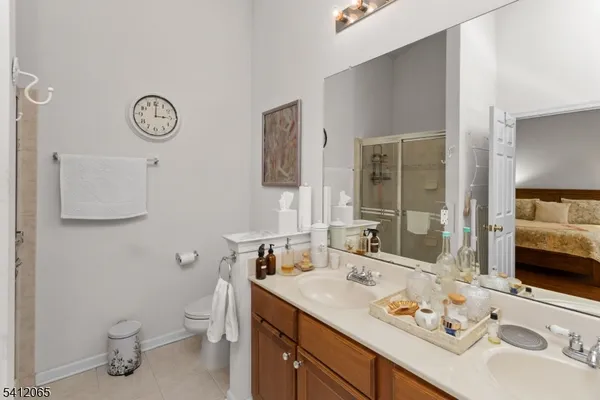 a bathroom with a sink vanity granite and toilet