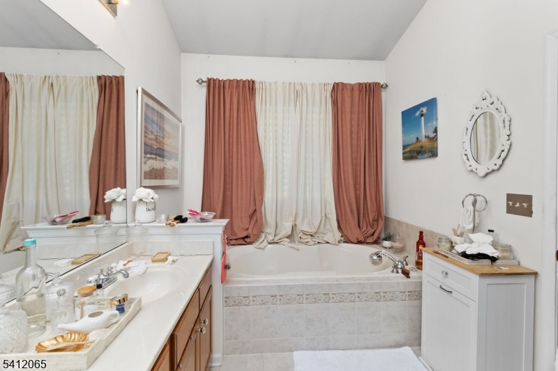 411 Deluca Road, Unit 411 Belleville, NJ 07109 - Photo 23 of 39 a bathroom with a granite countertop sink and a mirror