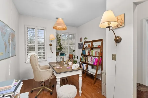 a dining room with furniture and a floor to ceiling window