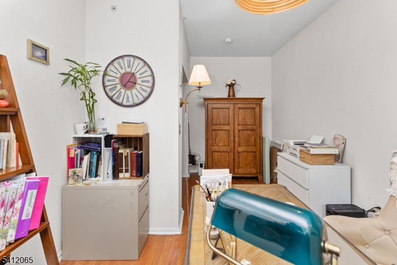411 Deluca Road, Unit 411 Belleville, NJ 07109 - Photo 25 of 39 a living room with furniture and a clock
