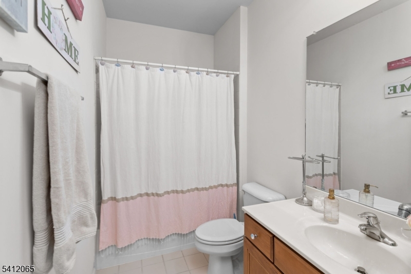 411 Deluca Road, Unit 411 Belleville, NJ 07109 - Photo 26 of 39 a bathroom with a sink toilet and shower