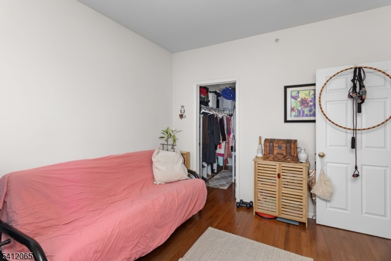 411 Deluca Road, Unit 411 Belleville, NJ 07109 - Photo 28 of 39 a bedroom with a bed and wooden floor