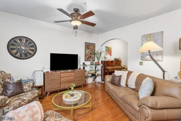 a living room with furniture a flat screen tv and a table