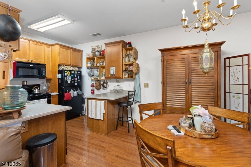 411 Deluca Road, Unit 411 Belleville, NJ 07109 - Photo 10 of 39 a room with stainless steel appliances kitchen island granite countertop furniture and a wooden floor