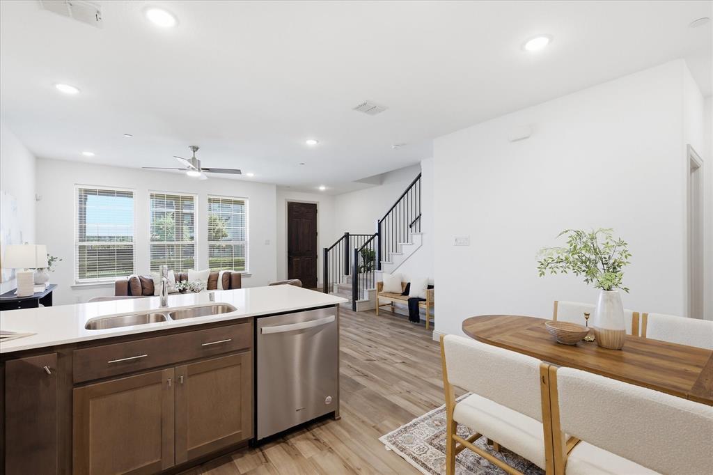 6141 Roper Road McKinney, TX 75070 - Photo 13 of 35 Open-concept living area featuring wood-finish flooring, recessed lighting, and a contemporary ceiling fan