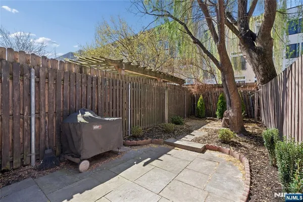 a view of garden with wooden fence