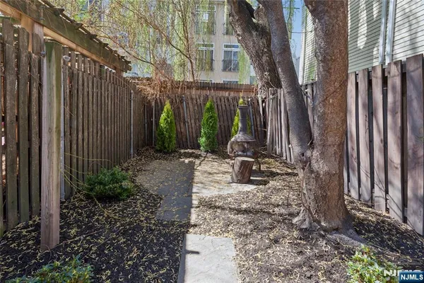 a backyard of a house with table and chairs