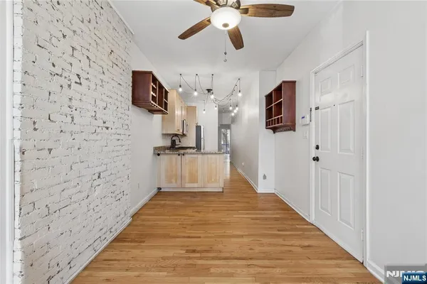 a view of a hallway with wooden floor and staircase