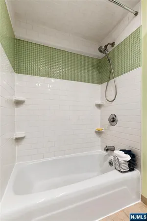 a bathroom with a shower and a bathtub
