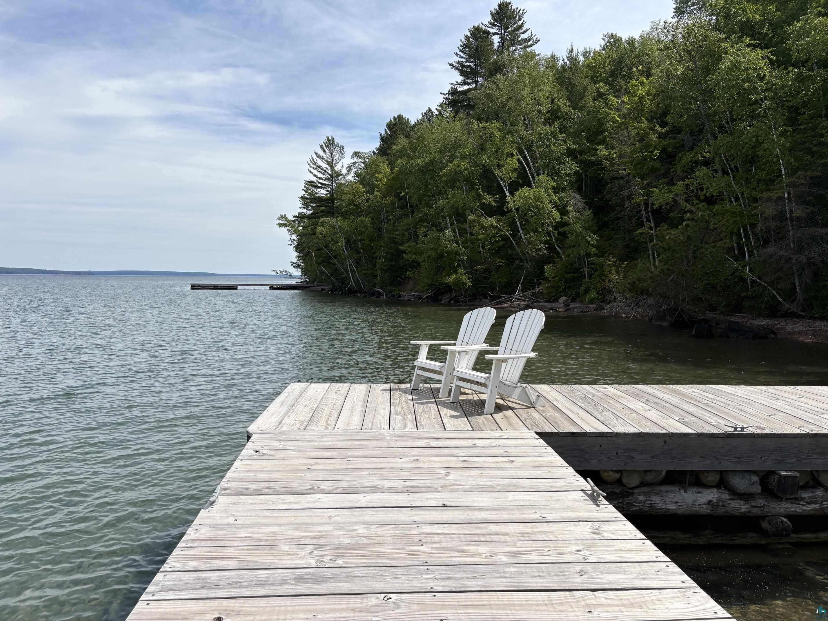 1596 North Shore Road La Pointe, WI 54850 - Photo 20 of 21 Expansive wooden dock extending over calm waters, framed by a lush treeline