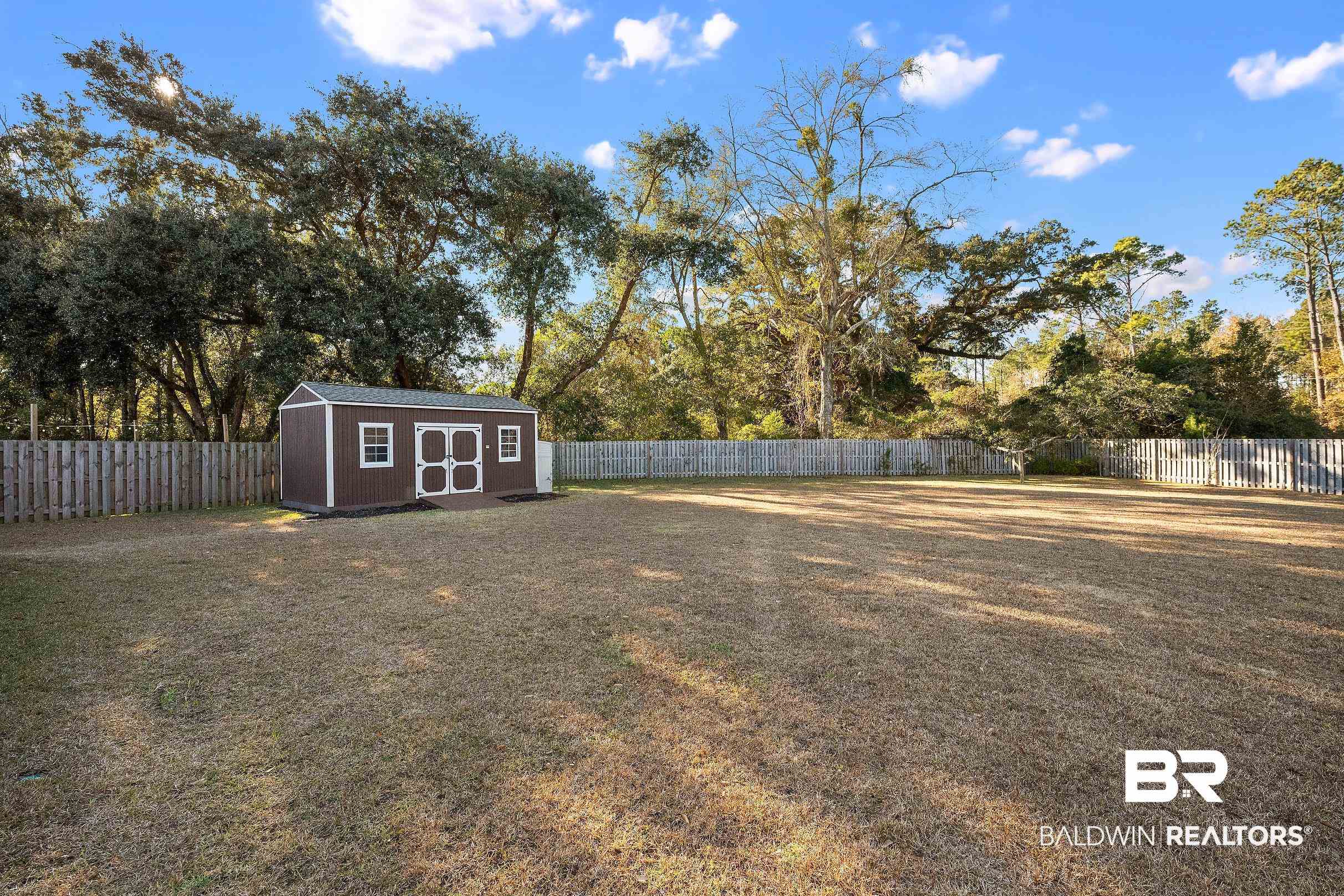 1077 Stella Road Foley, AL 36535 - Photo 3 of 27 Fenced backyard with a storage unit