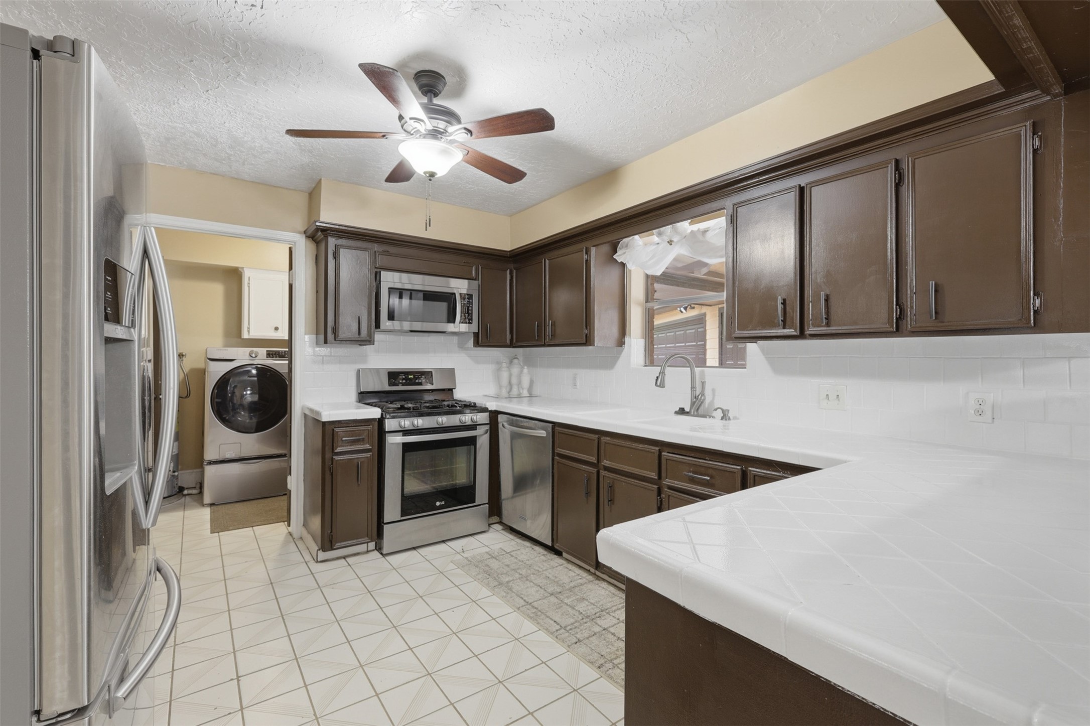 7010 River Mill Drive Spring, TX 77379 - Photo 11 of 29 a kitchen with a sink appliances and cabinets