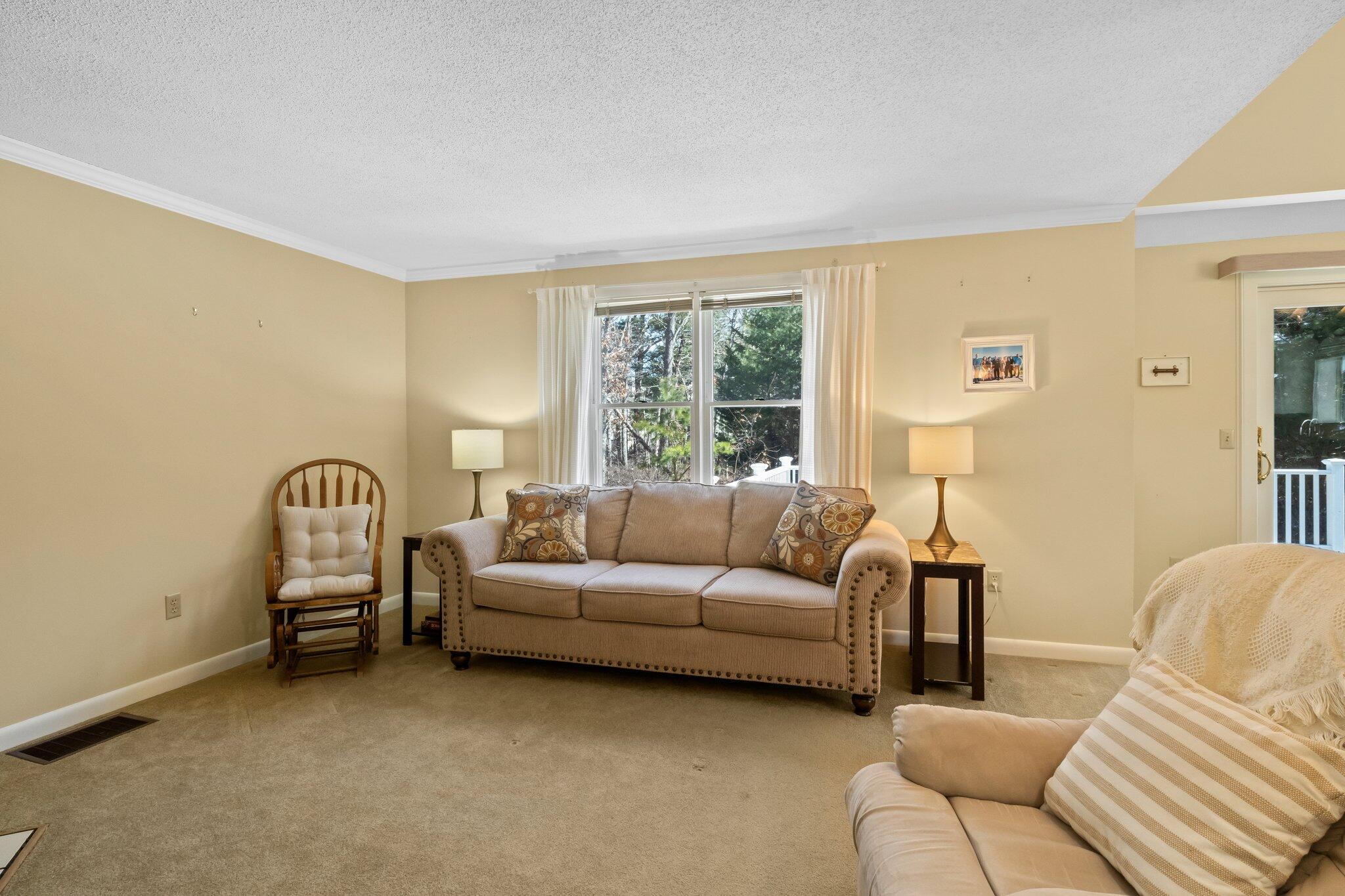91 Shellback Way, Unit N Mashpee, MA 02649 - Photo 12 of 40 a living room with furniture and a window