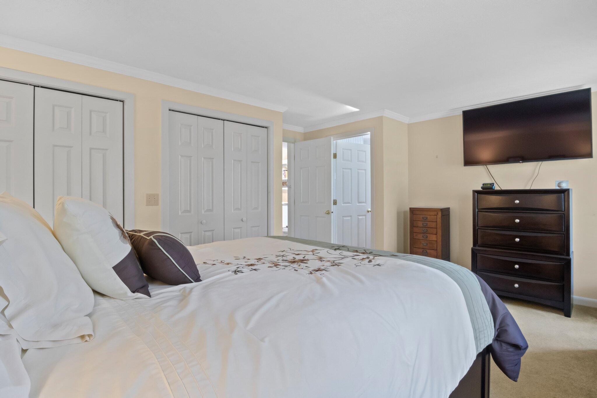 91 Shellback Way, Unit N Mashpee, MA 02649 - Photo 16 of 40 a bedroom with a bed and a flat screen tv