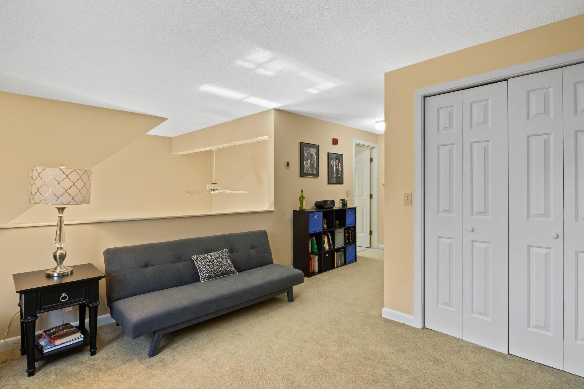 91 Shellback Way, Unit N Mashpee, MA 02649 - Photo 20 of 40 a living room with furniture and a walk in closet