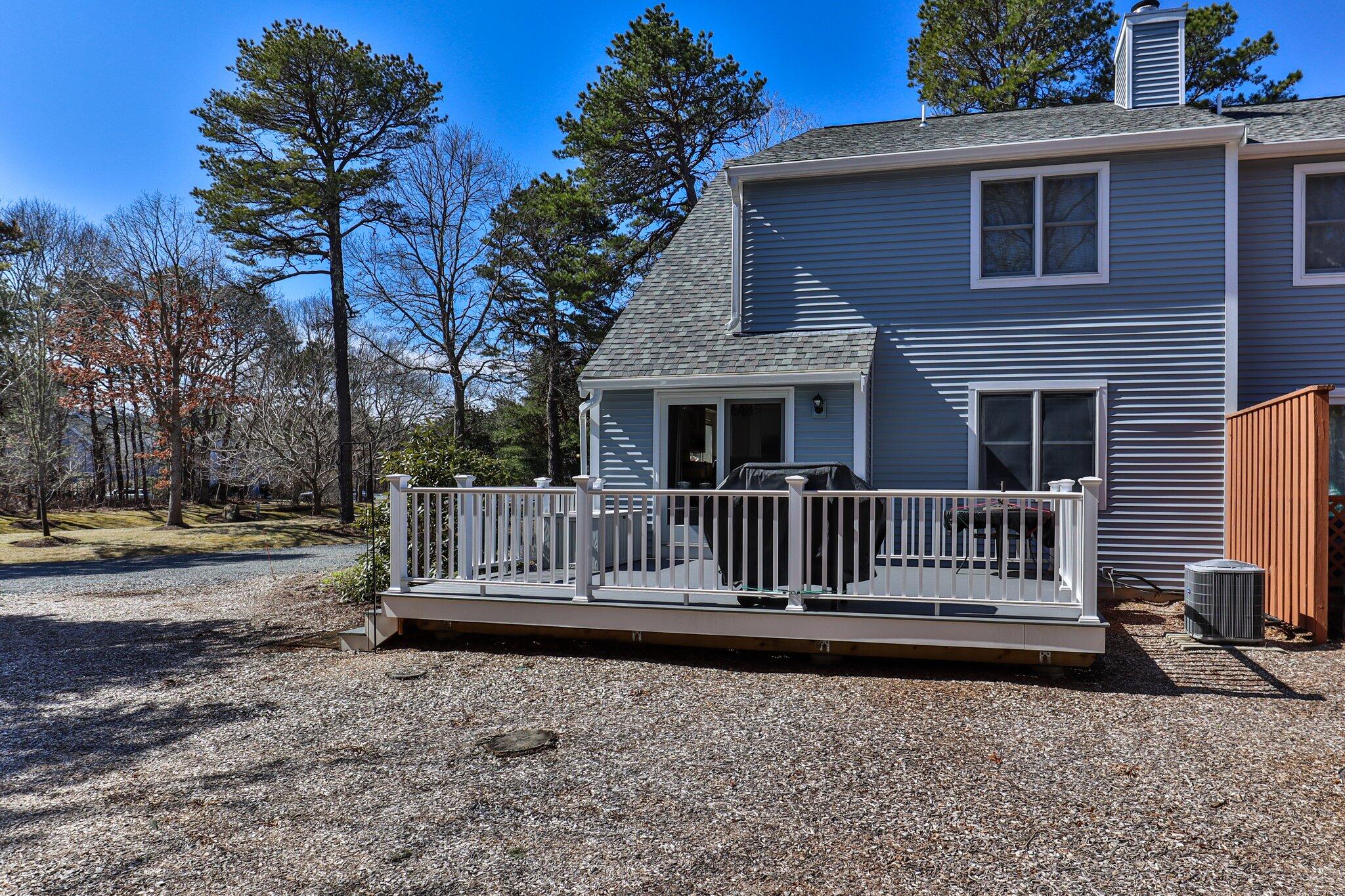 91 Shellback Way, Unit N Mashpee, MA 02649 - Photo 27 of 40 a view of a bench in backyard of house