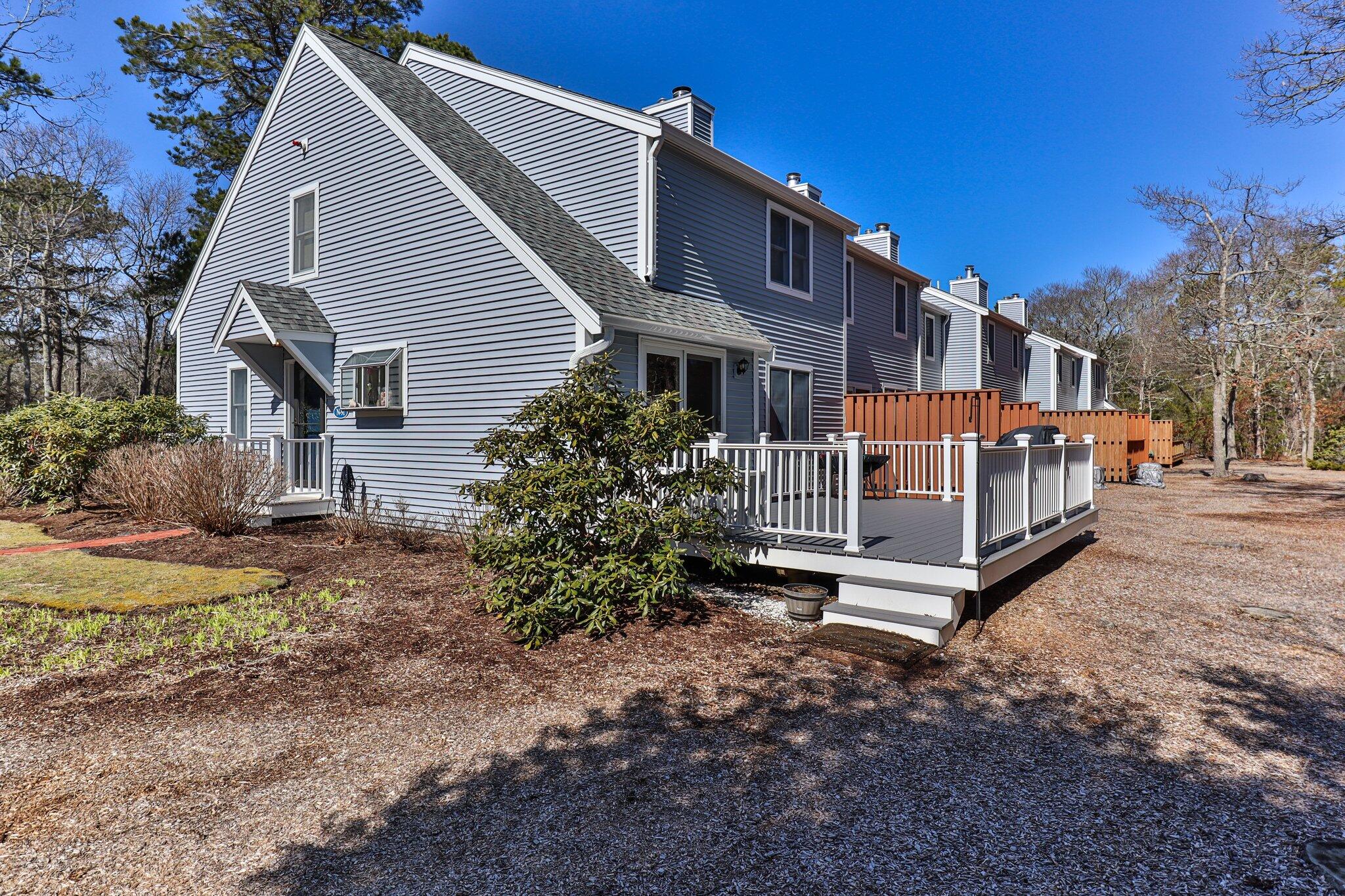 91 Shellback Way, Unit N Mashpee, MA 02649 - Photo 28 of 40 a view of a house with a yard