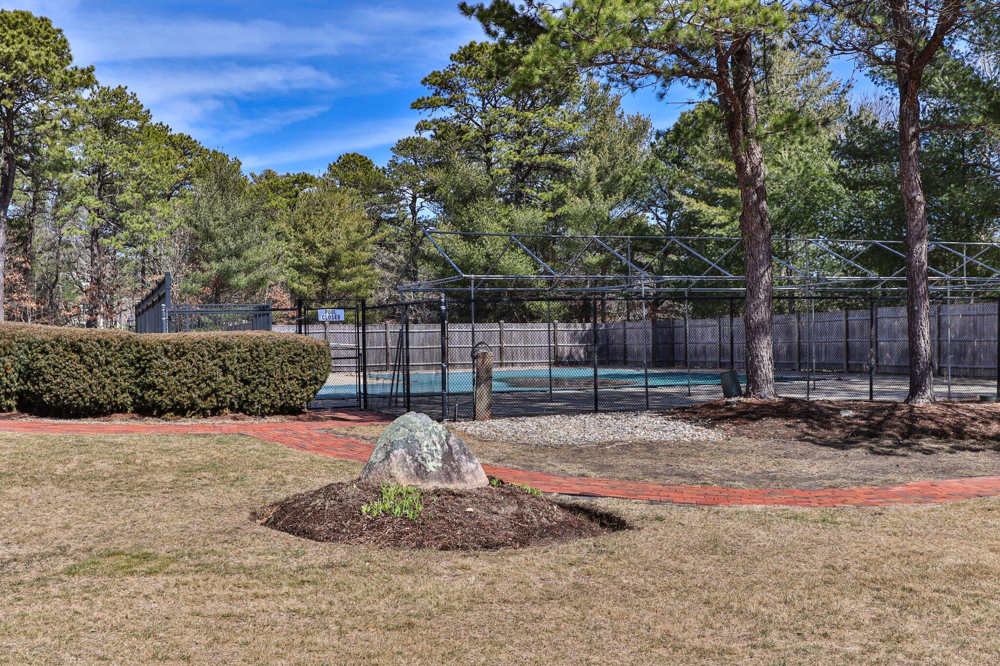 91 Shellback Way, Unit N Mashpee, MA 02649 - Photo 34 of 40 a backyard of a house with lots of green space