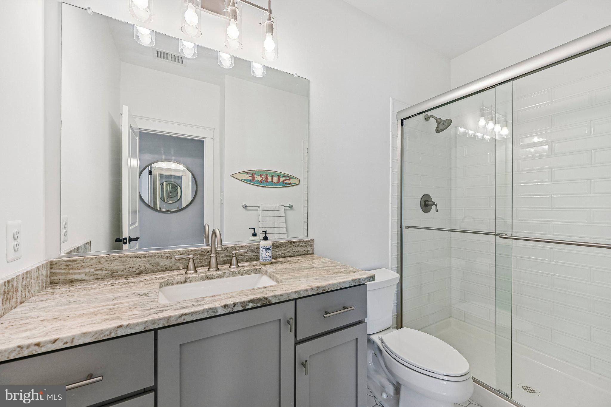 14516 Old Frederick Road Cooksville, MD 21723 - Photo 51 of 100 a bathroom with a granite countertop sink mirror toilet and shower