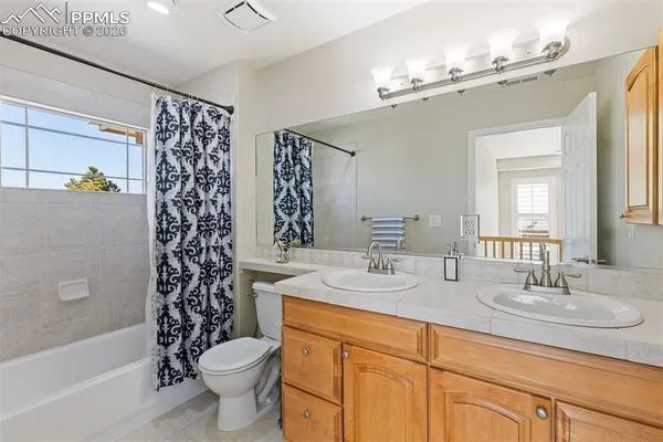a spacious bathroom with a granite countertop sink and a mirror